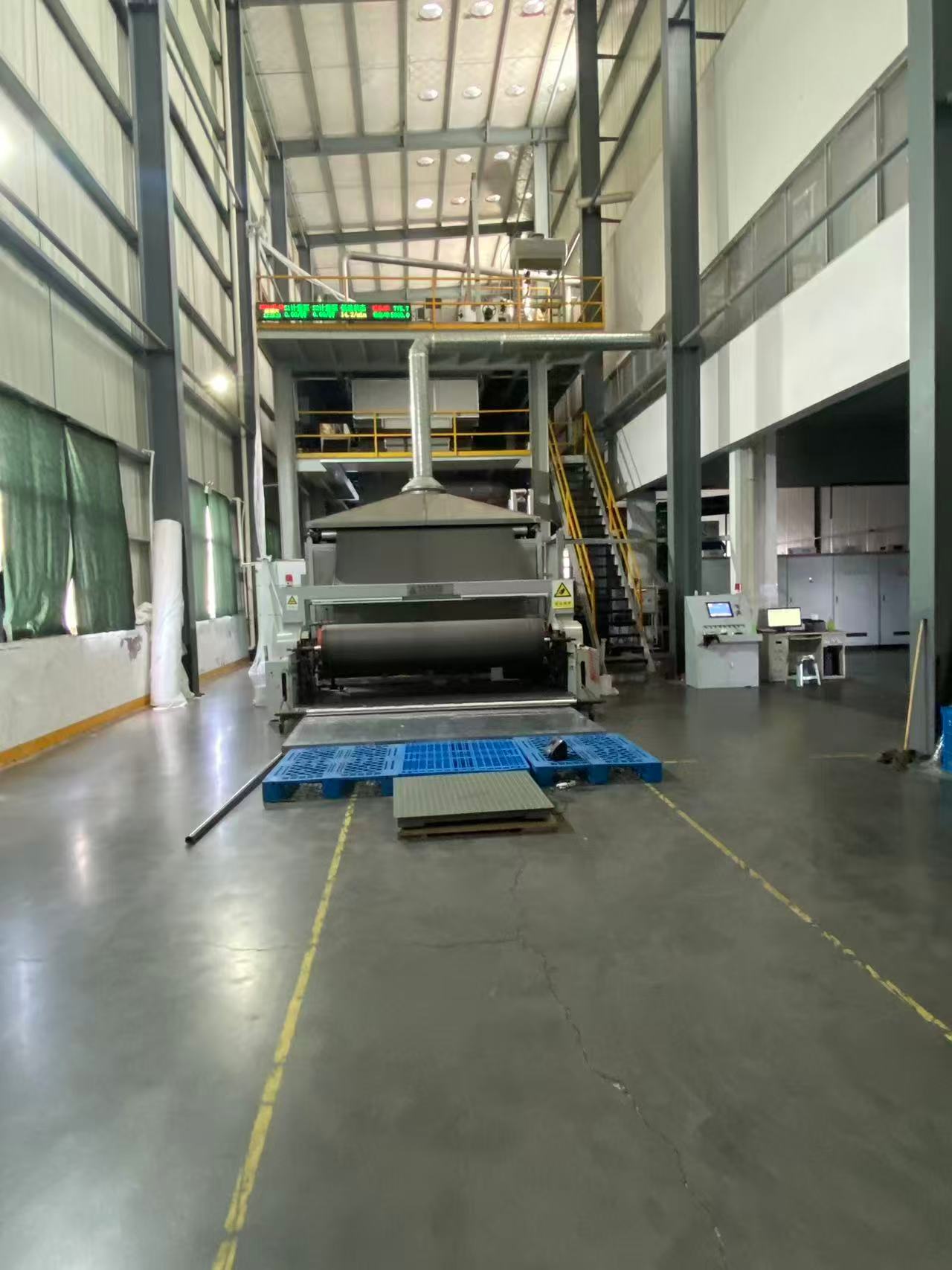 Spunbond production line with control station inside the Xinhaokai workshop